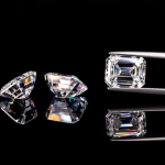 Close-up showing the difference in brilliance and fire between a moissanite and a diamond gemstone.