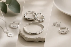 Comparison of sterling silver, pure silver, and silver-plated jewelry pieces on a minimalist background